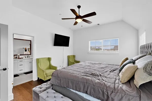 a bedroom with a bed a couch and a window