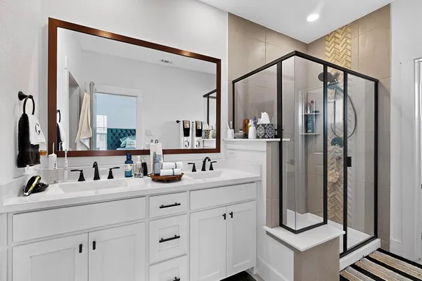 a bathroom with a double vanity sink mirror and double