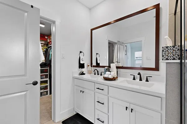 a bathroom with mirror and sink