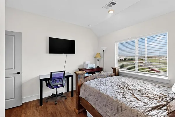 a bedroom with a bed and a flat screen tv