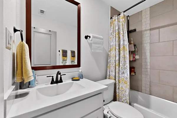 a bathroom with a sink toilet tub and shower