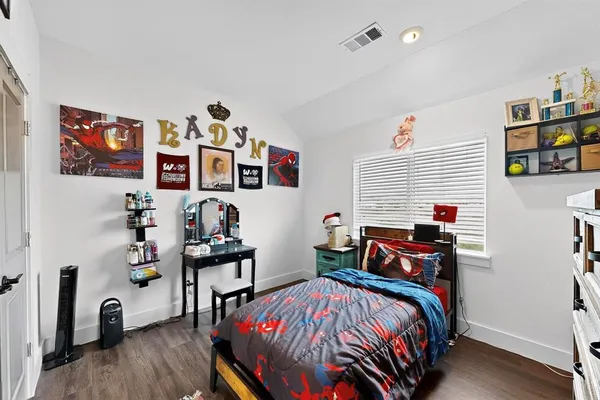 a bedroom with bed and a bookshelf