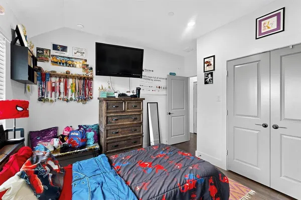 a bedroom with a bed and a flat screen tv