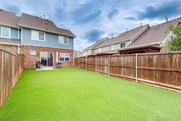 a view of a house with a backyard