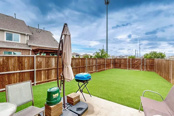 a view of a chairs in patio and a yard