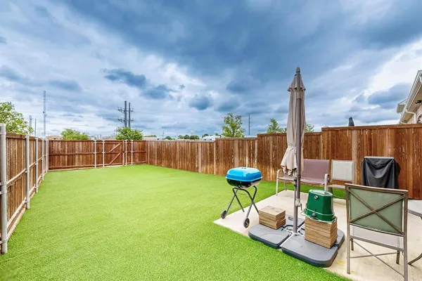 a garden view with a seating space and fir pit