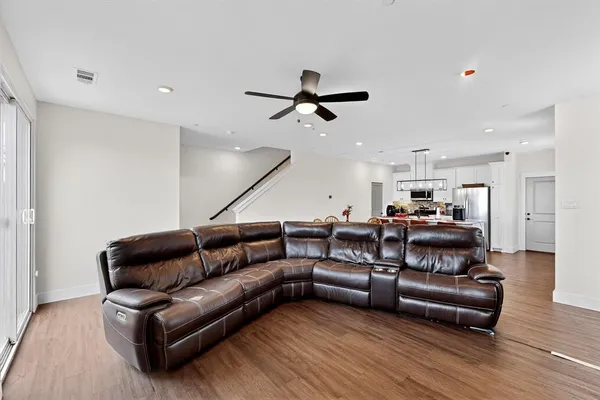 a living room with furniture and wooden floor