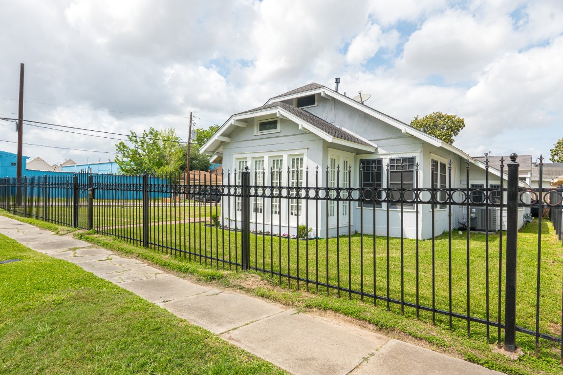 5401 North Capitol Street Houston, TX 77011 - Photo 2 of 39 a view of a house with a small yard and large trees