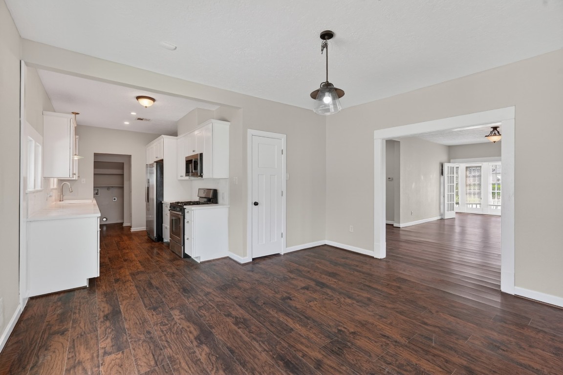 5401 North Capitol Street Houston, TX 77011 - Photo 21 of 39 a view of a kitchen with a refrigerator a ceiling fan and wooden floor