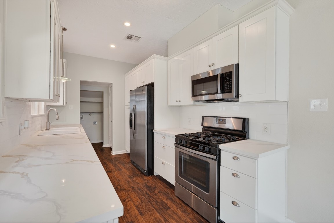 5401 North Capitol Street Houston, TX 77011 - Photo 24 of 39 a kitchen with a sink a microwave and refrigerator