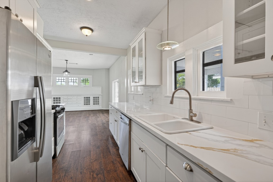 5401 North Capitol Street Houston, TX 77011 - Photo 25 of 39 a kitchen with stainless steel appliances granite countertop a sink a stove and a refrigerator