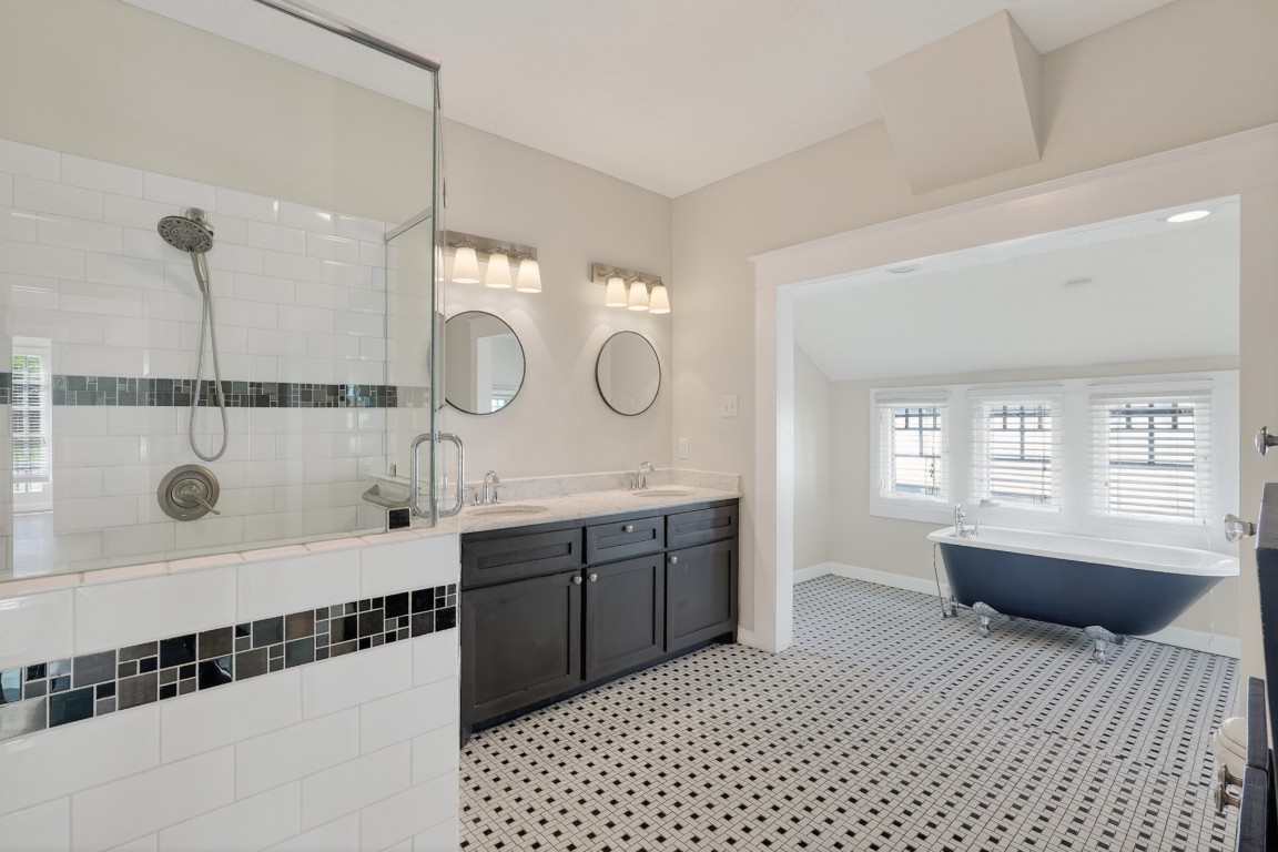 5401 North Capitol Street Houston, TX 77011 - Photo 27 of 39 a spacious bathroom with a shower a sink and a mirror