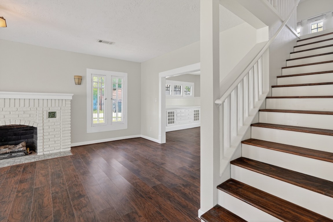 5401 North Capitol Street Houston, TX 77011 - Photo 30 of 39 a view of entryway with wooden floor and a fireplace