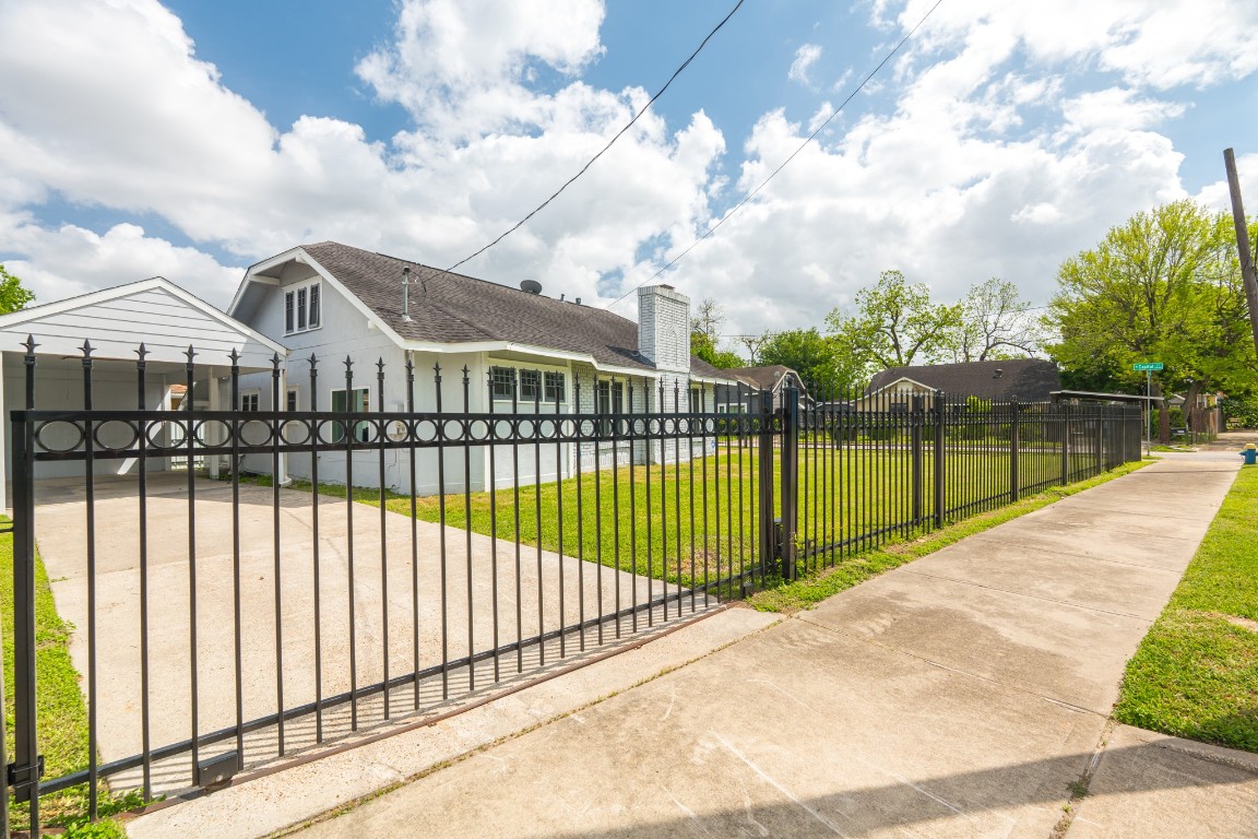5401 North Capitol Street Houston, TX 77011 - Photo 35 of 39 a view of a white house with a large trees next to a yard