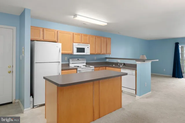 a kitchen with appliances cabinets and a sink
