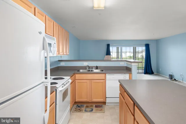 a kitchen with a stove a sink and a refrigerator