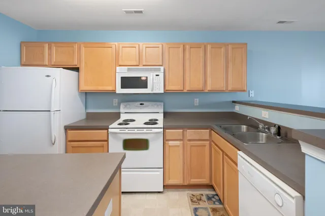 a kitchen with a stove a sink and a refrigerator