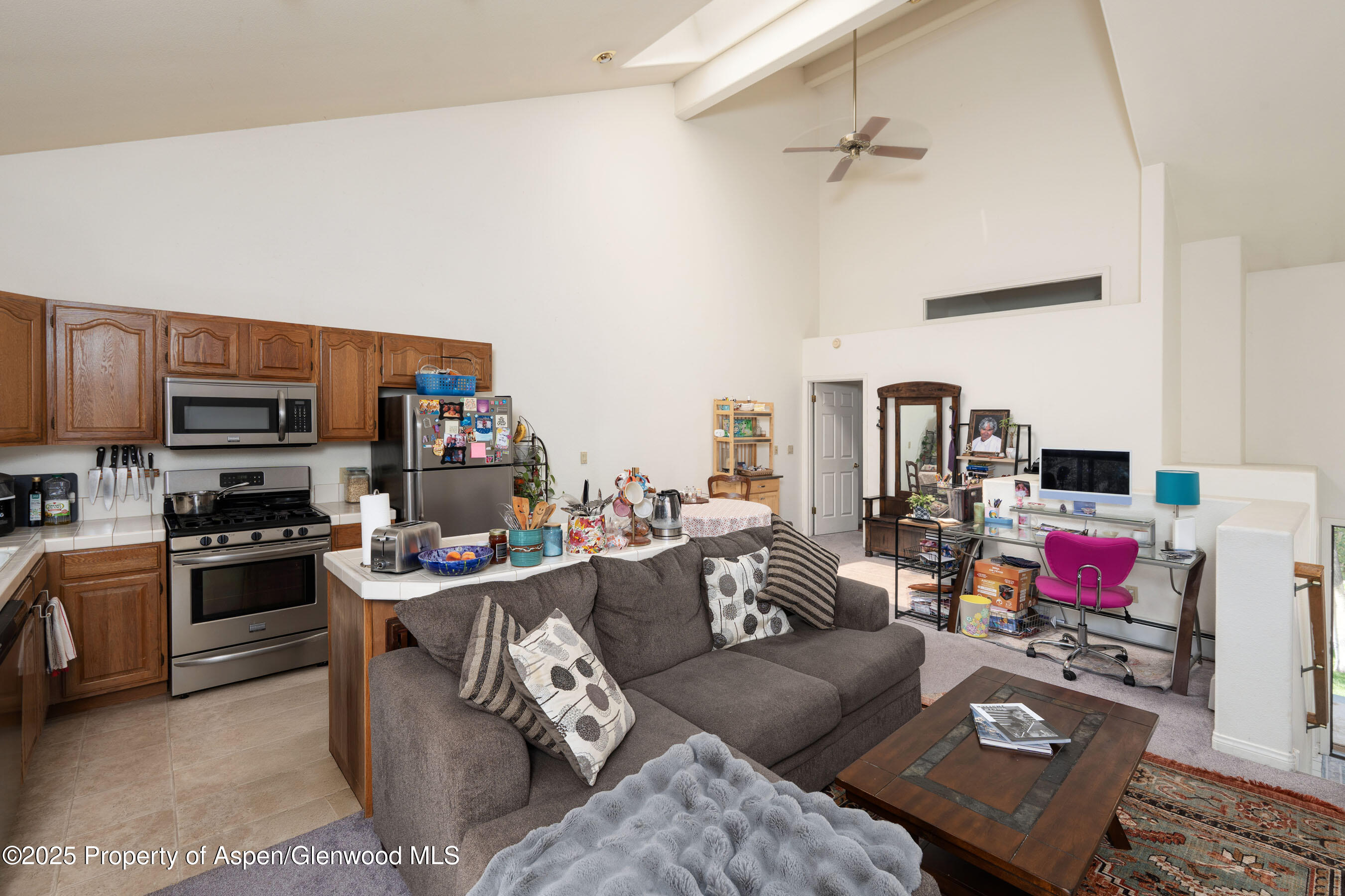 1506 Mockingbird Lane, Unit 11A Basalt, CO 81621 - Photo 8 of 8 a living room with furniture a flat screen tv and a stove