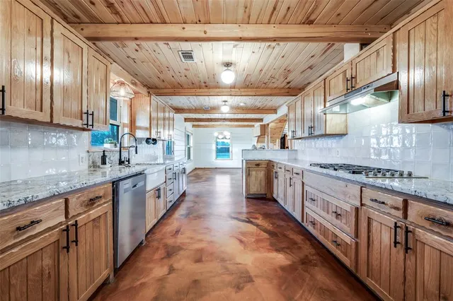 a kitchen with stainless steel appliances granite countertop a stove and a sink
