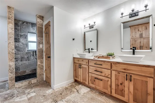 a spacious bathroom with a double vanity sink and a mirror