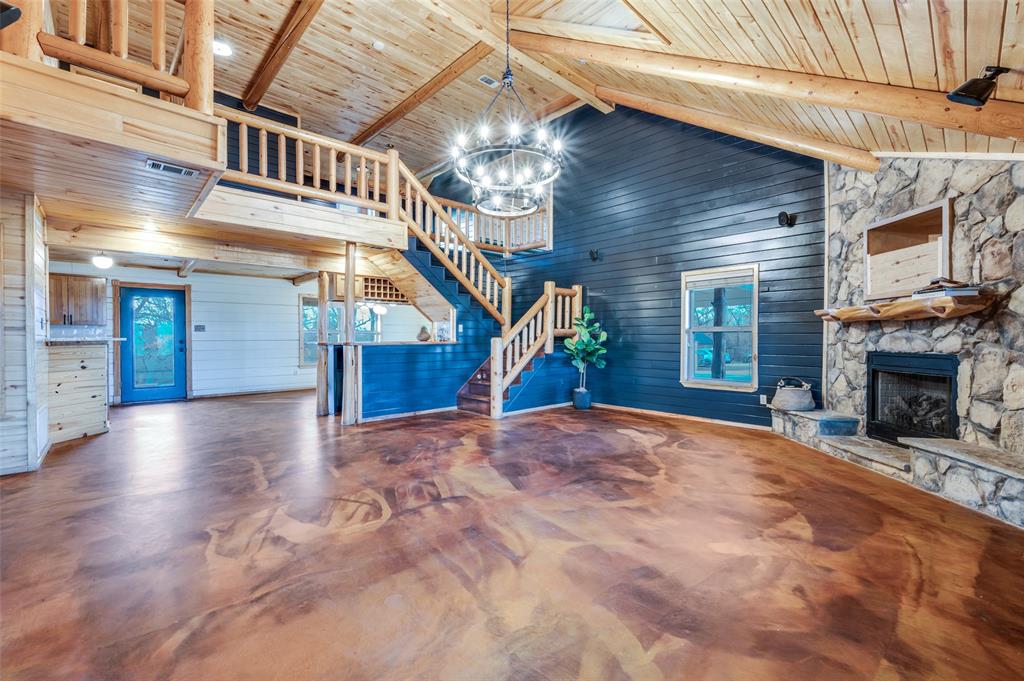 1353 Spring Creek Road Collinsville, TX 76233 - Photo 21 of 40 a view of a livingroom with fireplace stairs and windows