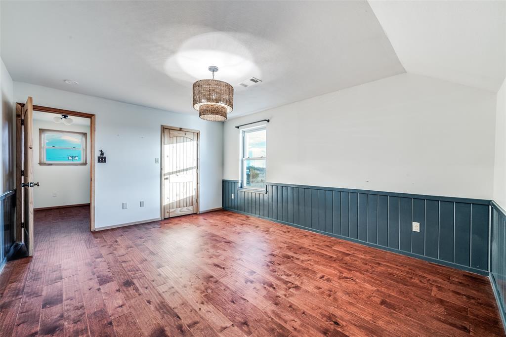 1353 Spring Creek Road Collinsville, TX 76233 - Photo 25 of 40 an empty room with wooden floor and windows