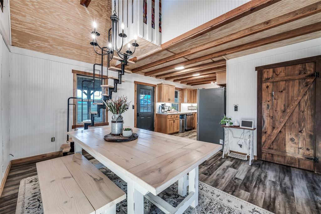 1353 Spring Creek Road Collinsville, TX 76233 - Photo 29 of 40 a view of a dining room with furniture and wooden floor