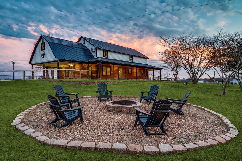 1353 Spring Creek Road Collinsville, TX 76233 - Photo 35 of 40 a view of a patio with table and chairs with a yard