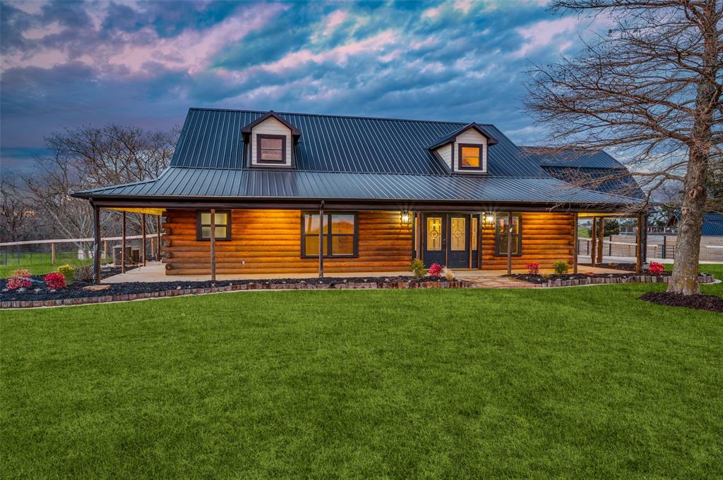 1353 Spring Creek Road Collinsville, TX 76233 - Photo 5 of 40 a front view of a house with garden