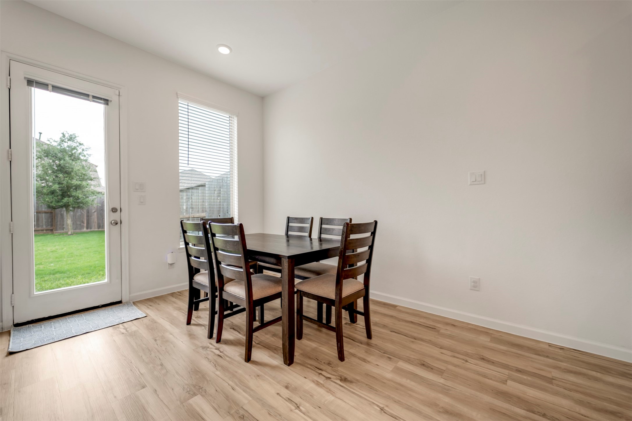 4127 Champlain Way Iowa Colony, TX 77583 - Photo 10 of 35 a view of a dining room with furniture and wooden floor