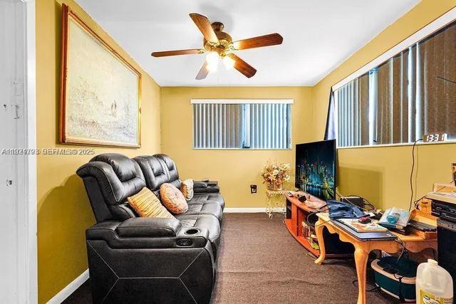 a living room with furniture a air conditioner vent and a window