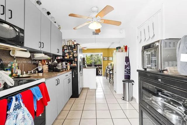 a kitchen with stainless steel appliances granite countertop a refrigerator and a stove top oven