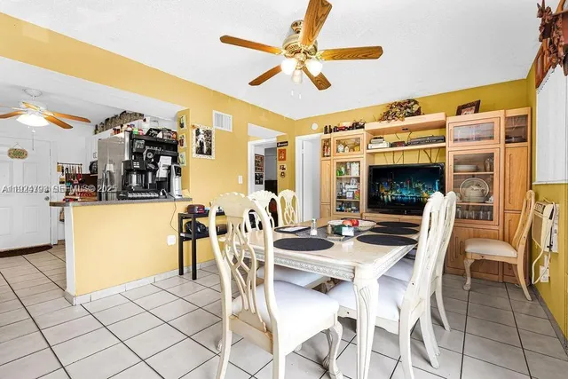 a view of a dining room with furniture and a chandelier