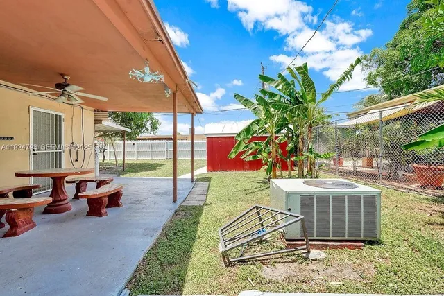 a view of a house with backyard porch and sitting area