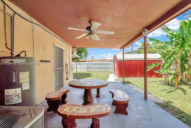 a view of a porch with furniture and a yard