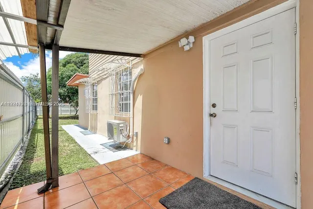 a view of a pathway of a house with wooden fence