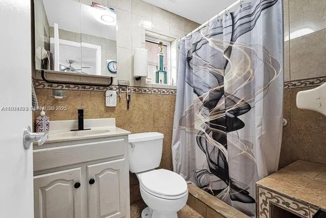 a white toilet sitting next to a bathroom sink