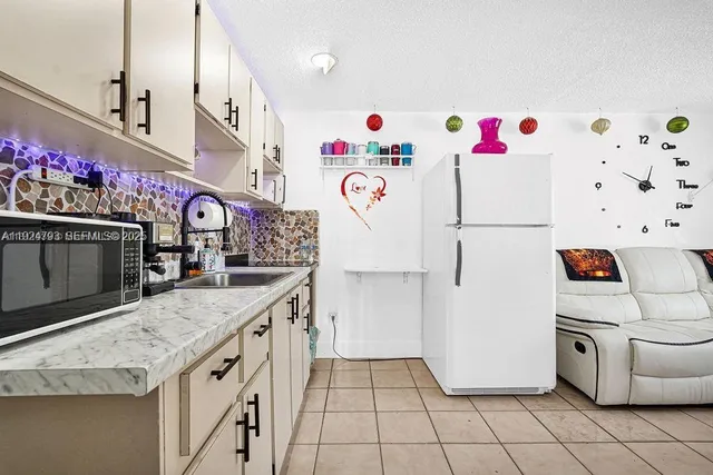 a kitchen with kitchen island a white stove top oven and cabinets
