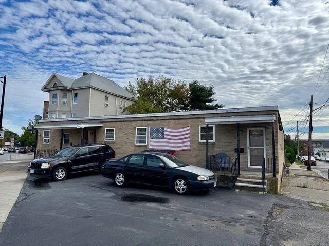 a car parked in front of a brick house