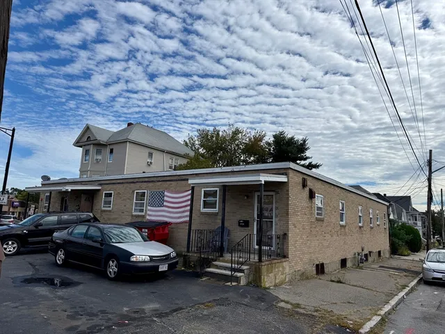 a car parked in front of a brick house