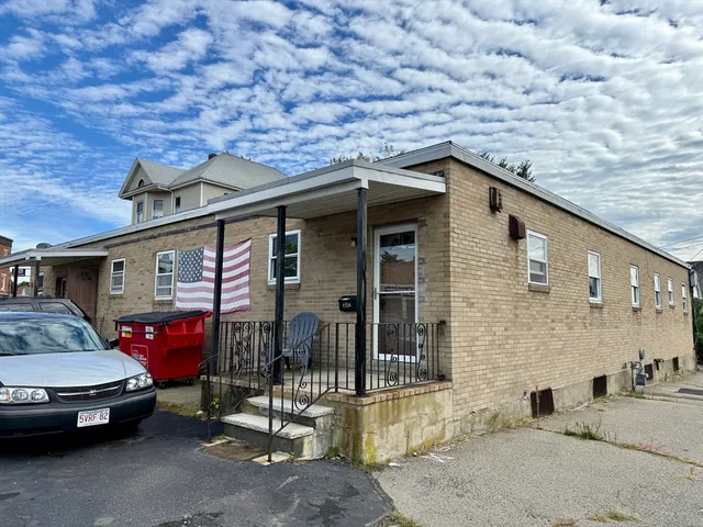 a car parked in front of a brick building