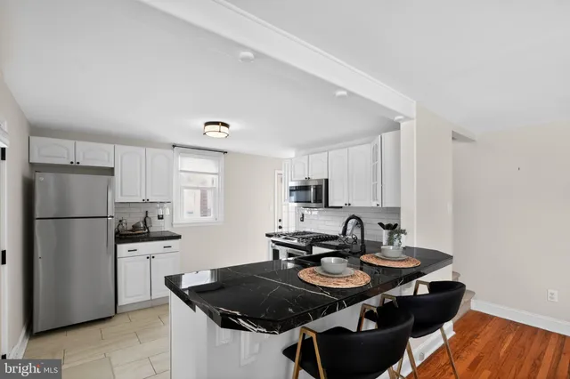 a kitchen with a sink stove and refrigerator