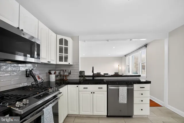 a kitchen with a sink stove top oven and cabinets