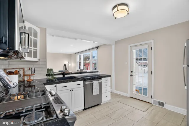 a kitchen with cabinets and window