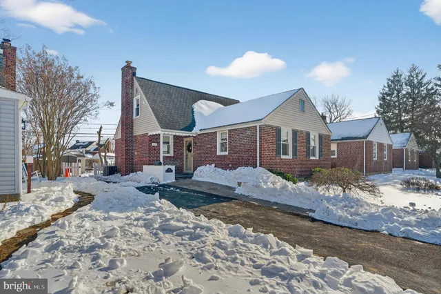 a view of a house with a snow on the road