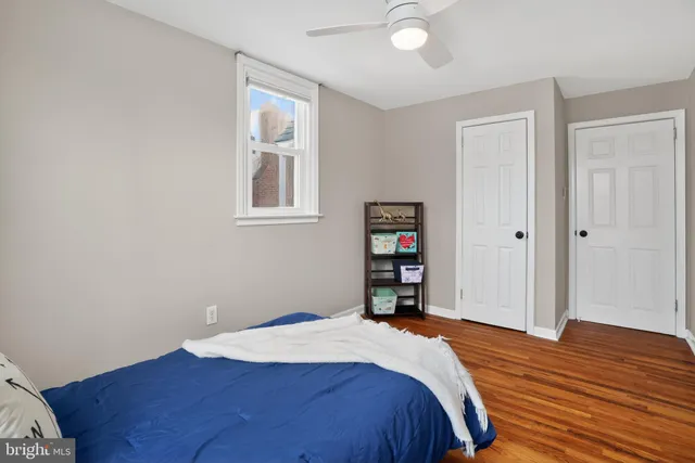 a bedroom with a bed and a wooden floor