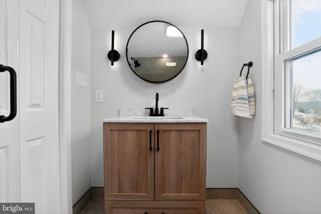 a bathroom with a sink and a mirror
