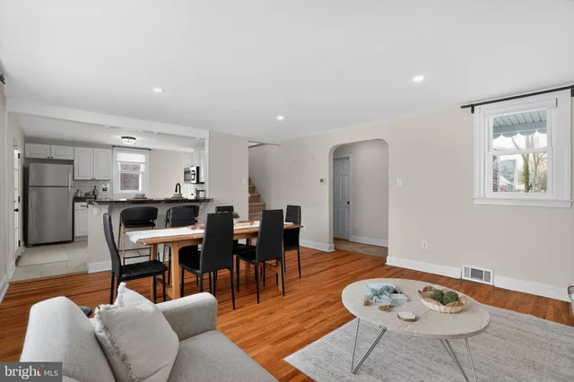 a living room with furniture a dining table and a dining table with wooden floor