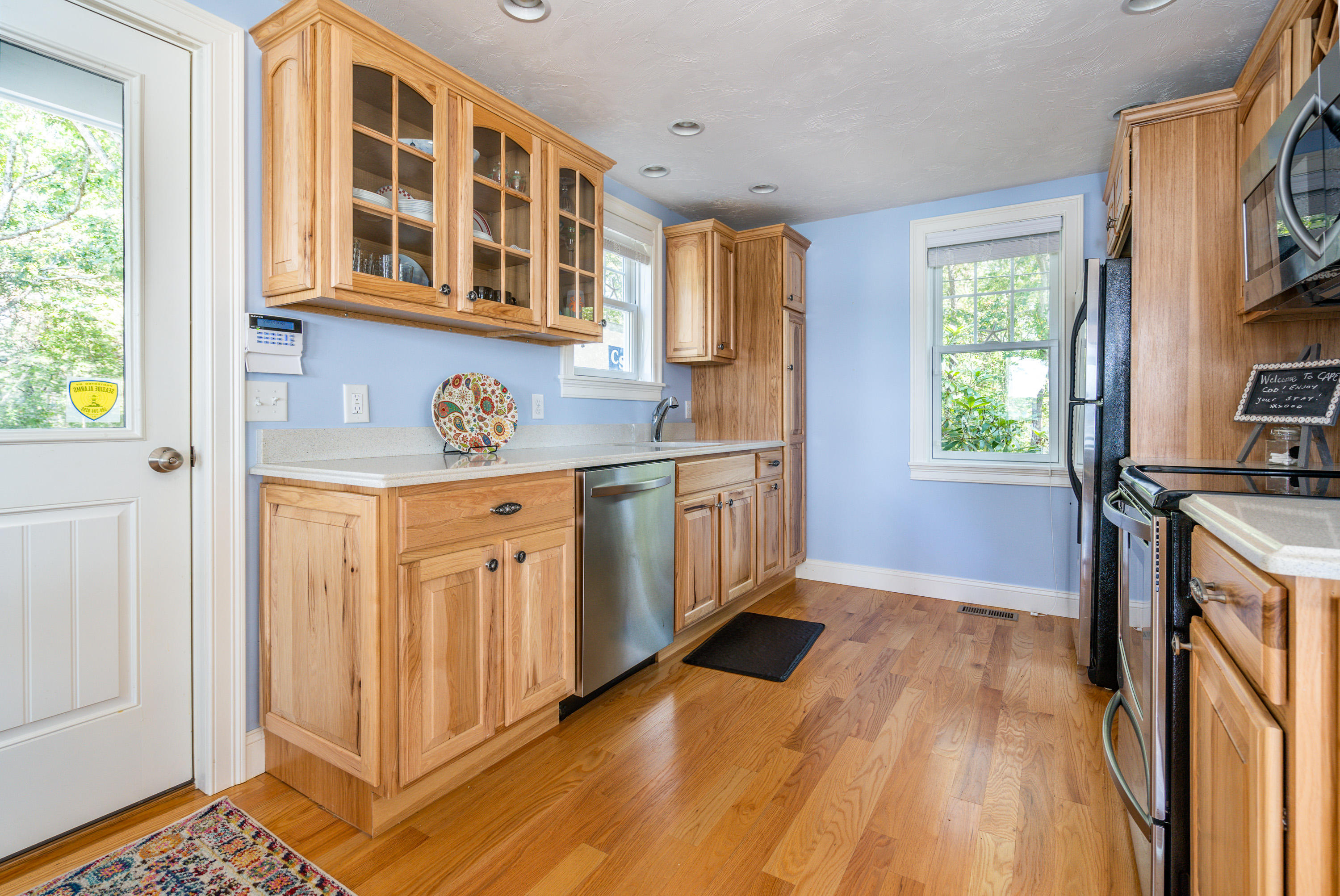 17 Monomoscoy Road West Mashpee, MA 02649 - Photo 13 of 36 a kitchen with stainless steel appliances granite countertop a stove a sink and a refrigerator with wooden floors