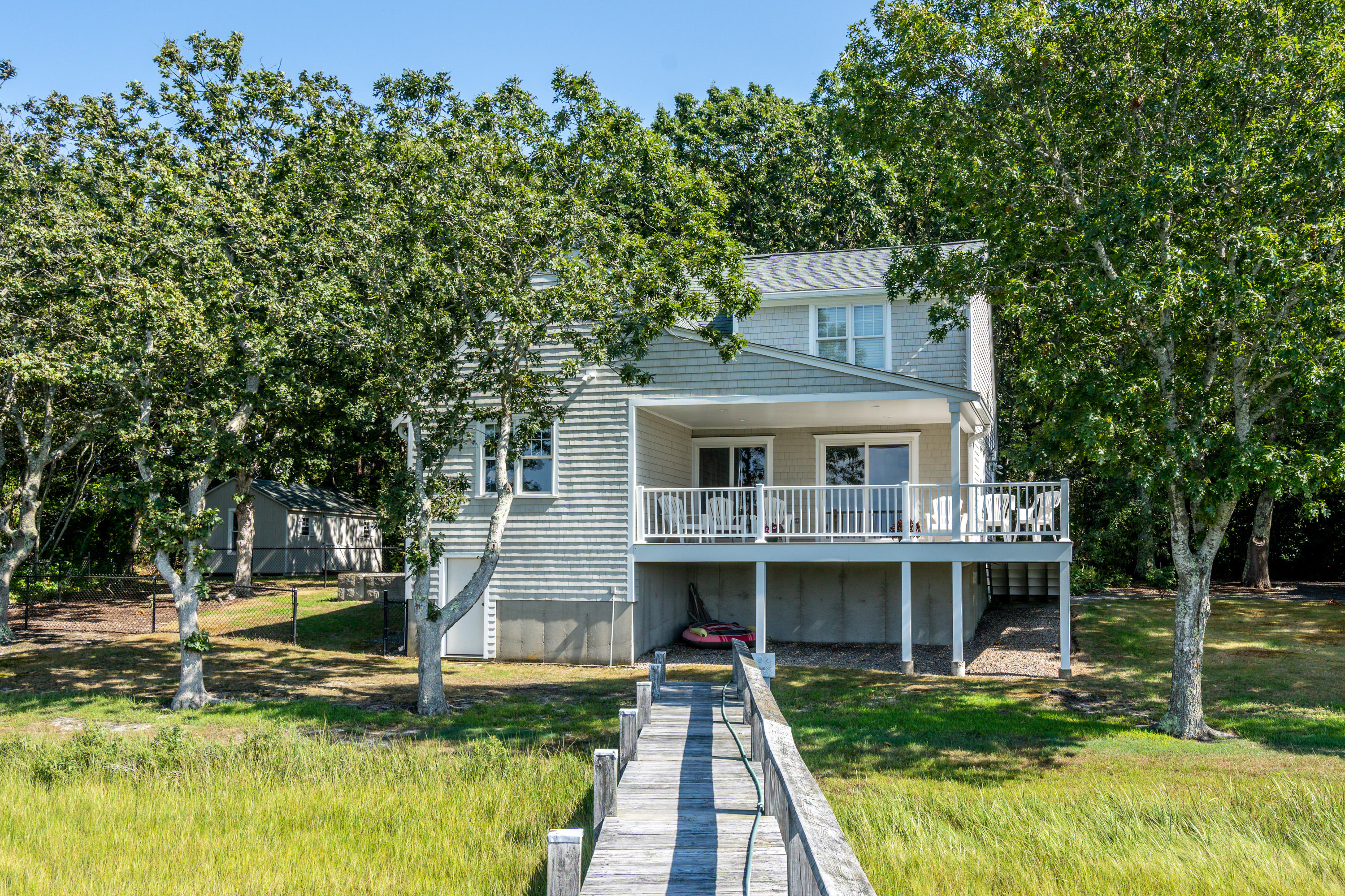 17 Monomoscoy Road West Mashpee, MA 02649 - Photo 2 of 36 a front view of a house with a yard
